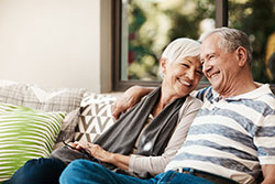 smiling mature couple on couch