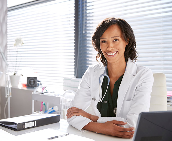 smiling female doctor at desk